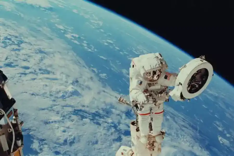 Astronaut Franklin R. Chang-Diaz works with a grapple fixture during extravehicular activity to perform work on the International Space Station